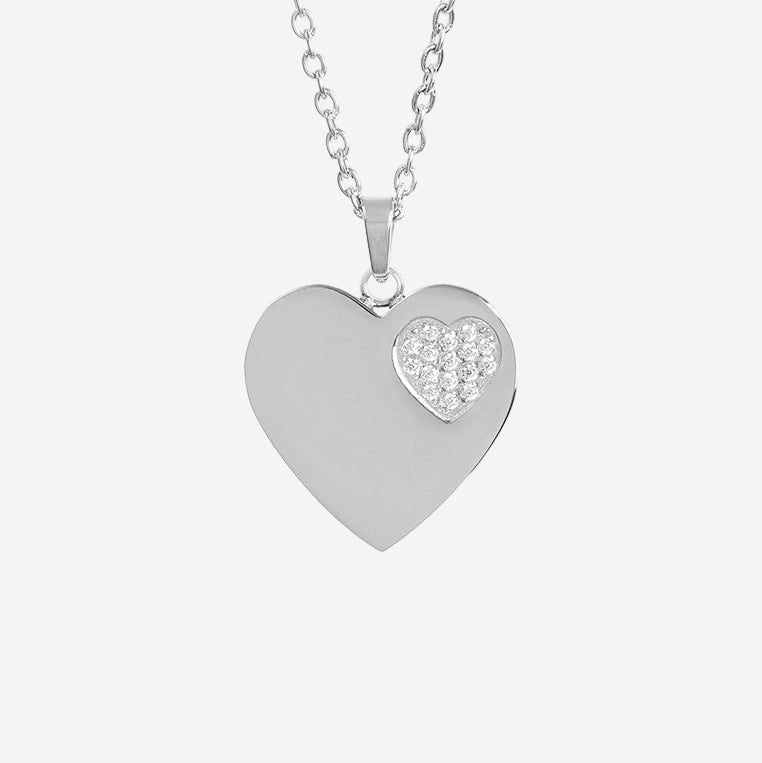 Silver heart-shaped pendant necklace with a smaller heart-cut gemstone on a light gray background