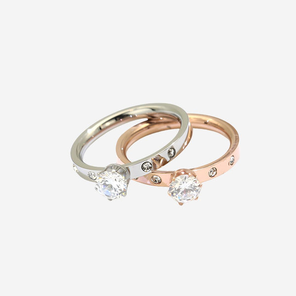 Two diamond rings on a light gray background