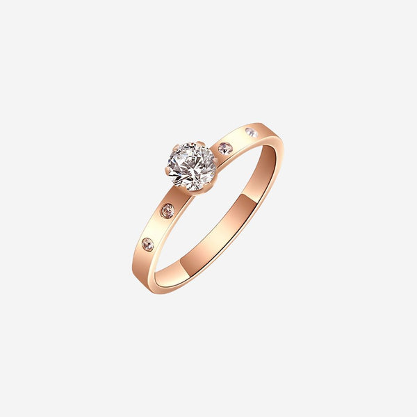 Rose gold ring with a diamond on a white background